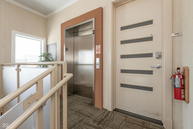 1036 Jackson St, Columbus, IN 47201 - hallway featuring elevator, dark carpet, and ornamental molding
