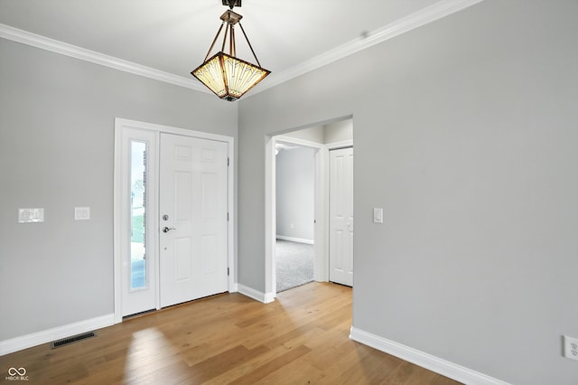 1127 Kay Dr, Greenwood, IN 46142 - entryway with light wood-style floors and ornamental molding
