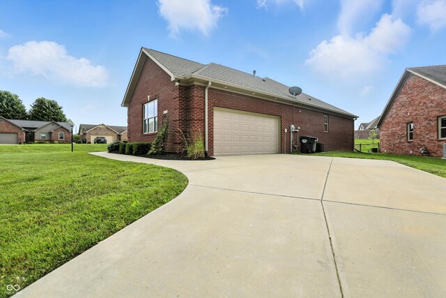 1127 Kay Dr, Greenwood, IN 46142 - view of home's exterior with brick siding, a lawn, driveway, and a garage