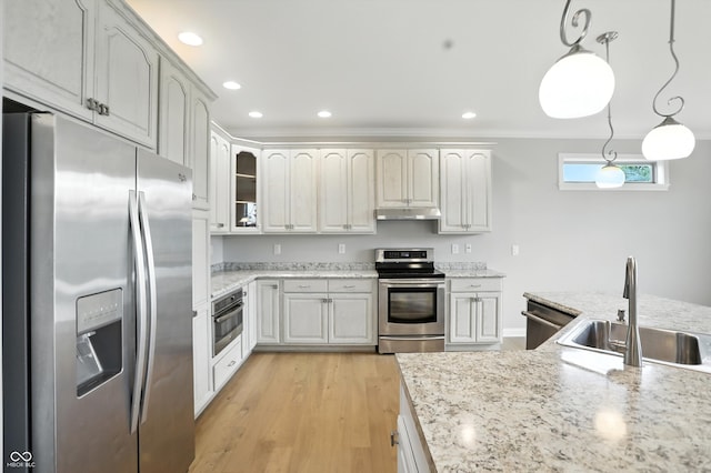 1127 Kay Dr, Greenwood, IN 46142 - kitchen featuring appliances with stainless steel finishes, under cabinet range hood, light wood-style flooring, decorative light fixtures, and glass insert cabinets