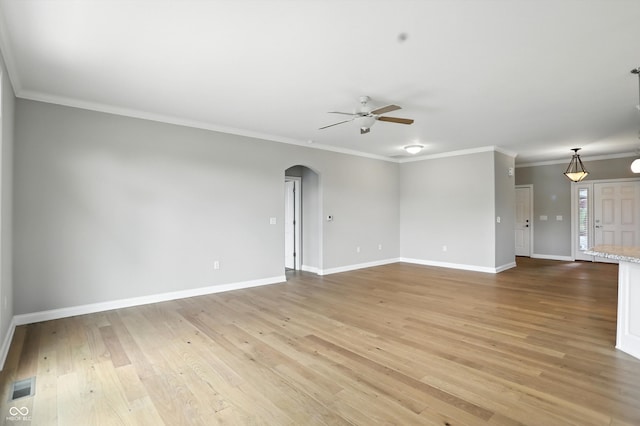 1127 Kay Dr, Greenwood, IN 46142 - empty room featuring ceiling fan, arched walkways, light wood finished floors, and ornamental molding