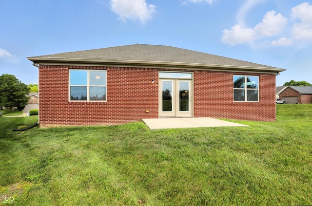 1127 Kay Dr, Greenwood, IN 46142 - rear view of property featuring a yard, a patio area, brick siding, and a shingled roof