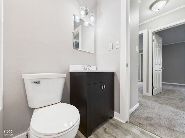 602 W 34th St, Anderson, IN 46013 - bathroom featuring vanity, crown molding, and wood finished floors
