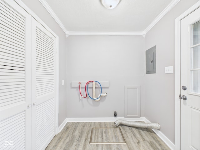 602 W 34th St, Anderson, IN 46013 - laundry room featuring electric panel, hookup for a washing machine, ornamental molding, and wood finished floors