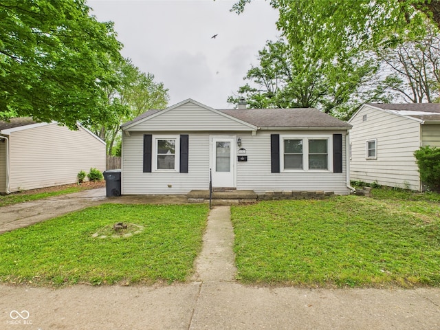 602 W 34th St, Anderson, IN 46013 - view of front facade with a front lawn, roof with shingles, and a chimney