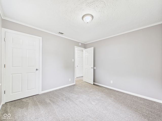602 W 34th St, Anderson, IN 46013 - unfurnished bedroom featuring carpet floors, a textured ceiling, and crown molding