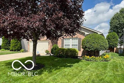 14459 Forsythia Ln, Fishers, IN 46038 - obstructed view of property with driveway, a front lawn, and a garage