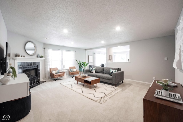 14459 Forsythia Ln, Fishers, IN 46038 - living room with carpet floors, recessed lighting, a tile fireplace, and a textured ceiling