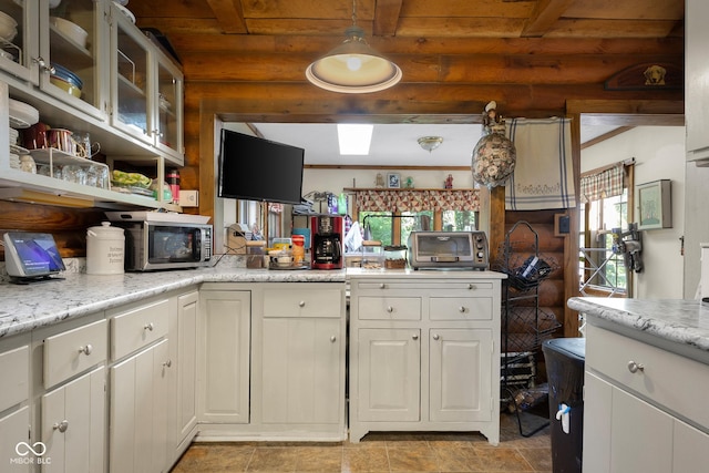 3370 E State Road 160, Salem, IN 47167 - kitchen featuring stainless steel microwave, white cabinets, beam ceiling, glass insert cabinets, and open shelves