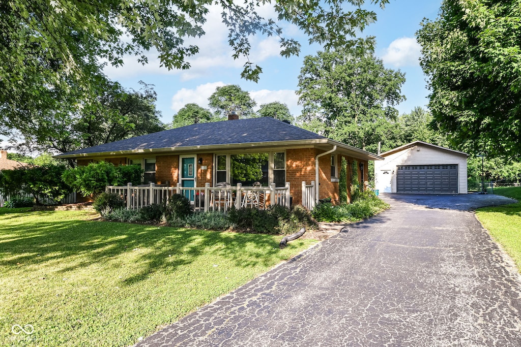 3515 Lindenwald Dr, Indianapolis, IN 46217 - ranch-style home with an outdoor structure, a garage, brick siding, and a front yard