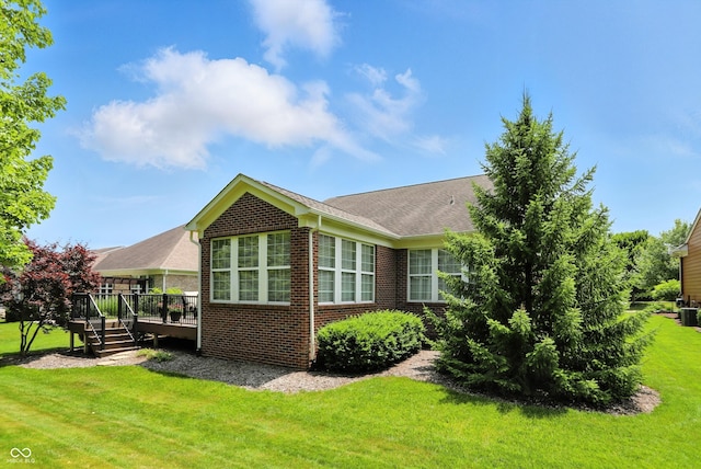 6570 Freemont Ln, Carmel, IN 46033 - view of side of property featuring brick siding, a deck, and a lawn