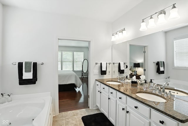 6570 Freemont Ln, Carmel, IN 46033 - ensuite bathroom featuring a bath, double vanity, and tile patterned floors