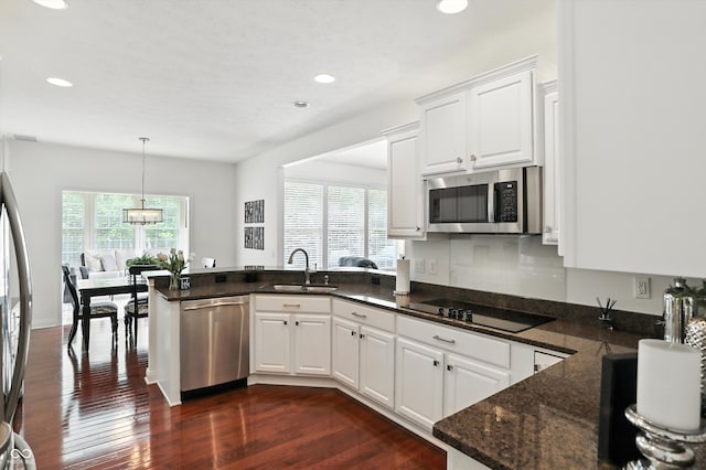 6570 Freemont Ln, Carmel, IN 46033 - kitchen with appliances with stainless steel finishes, healthy amount of natural light, recessed lighting, a peninsula, and white cabinets
