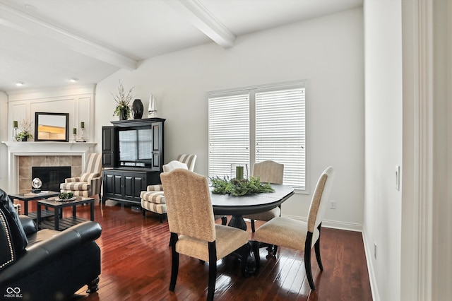 6570 Freemont Ln, Carmel, IN 46033 - dining space featuring beamed ceiling, a tiled fireplace, and dark wood-style floors