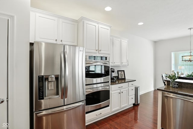 6570 Freemont Ln, Carmel, IN 46033 - kitchen featuring stainless steel appliances, dark wood-style floors, white cabinetry, a chandelier, and recessed lighting
