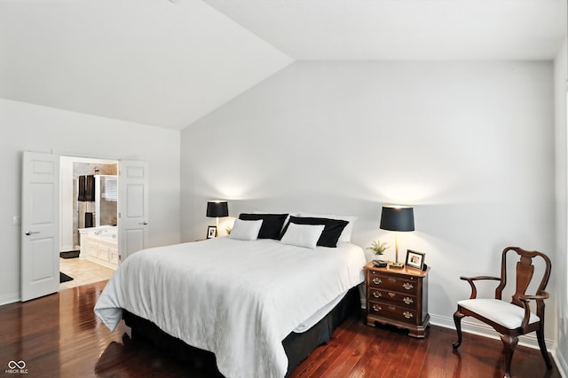 6570 Freemont Ln, Carmel, IN 46033 - bedroom with vaulted ceiling, dark wood-style floors, and ensuite bath