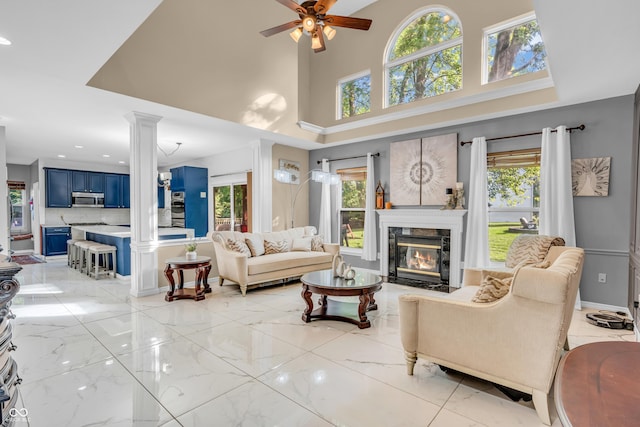 6374 Timberbluff Cir, Avon, IN 46123 - living room with ornate columns, a ceiling fan, healthy amount of natural light, a high end fireplace, and a high ceiling