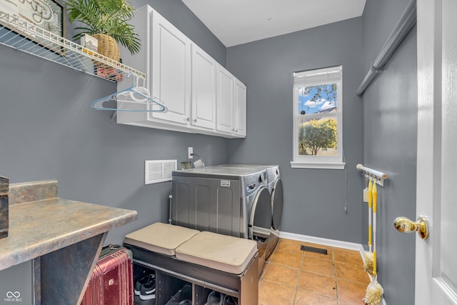 6374 Timberbluff Cir, Avon, IN 46123 - laundry area featuring cabinet space, washing machine and clothes dryer, and light tile patterned floors