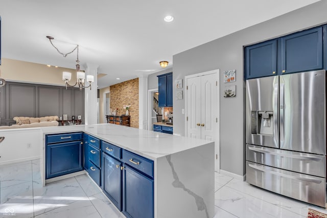 6374 Timberbluff Cir, Avon, IN 46123 - kitchen with stainless steel fridge, blue cabinets, light marble finish floors, a chandelier, and recessed lighting