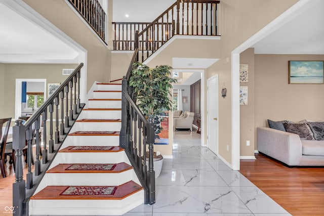 6374 Timberbluff Cir, Avon, IN 46123 - stairway with a towering ceiling and marble finish floors