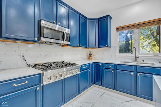 6374 Timberbluff Cir, Avon, IN 46123 - kitchen featuring appliances with stainless steel finishes, blue cabinetry, light stone counters, and light marble finish floors