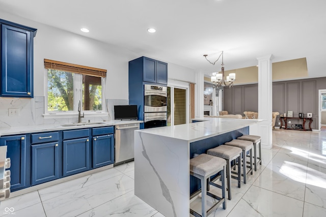 6374 Timberbluff Cir, Avon, IN 46123 - kitchen with appliances with stainless steel finishes, blue cabinetry, a kitchen bar, light marble finish floors, and recessed lighting