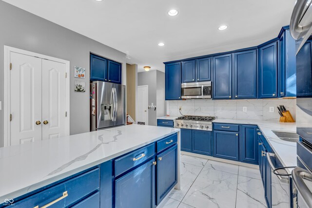 6374 Timberbluff Cir, Avon, IN 46123 - kitchen featuring stainless steel appliances, blue cabinets, light stone countertops, recessed lighting, and light marble finish floors