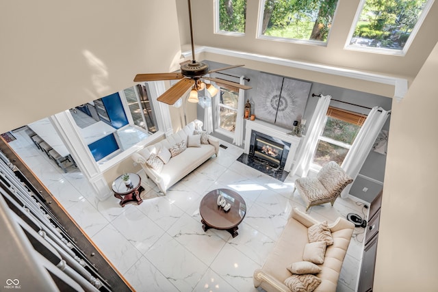 6374 Timberbluff Cir, Avon, IN 46123 - living room featuring a towering ceiling, a ceiling fan, and a high end fireplace
