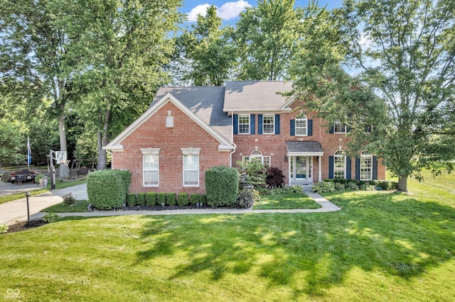 6374 Timberbluff Cir, Avon, IN 46123 - colonial house featuring brick siding, a front yard, and roof with shingles