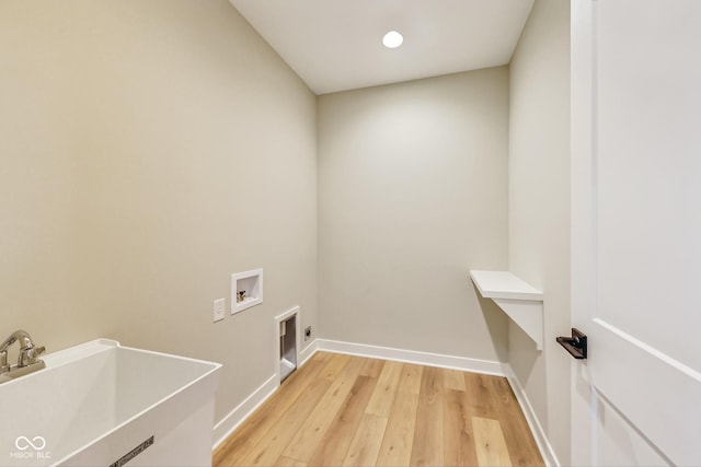 7604 Brownstone Ct, Greenfield, IN 46140 - laundry room featuring hookup for a washing machine, light wood-style floors, and electric dryer hookup