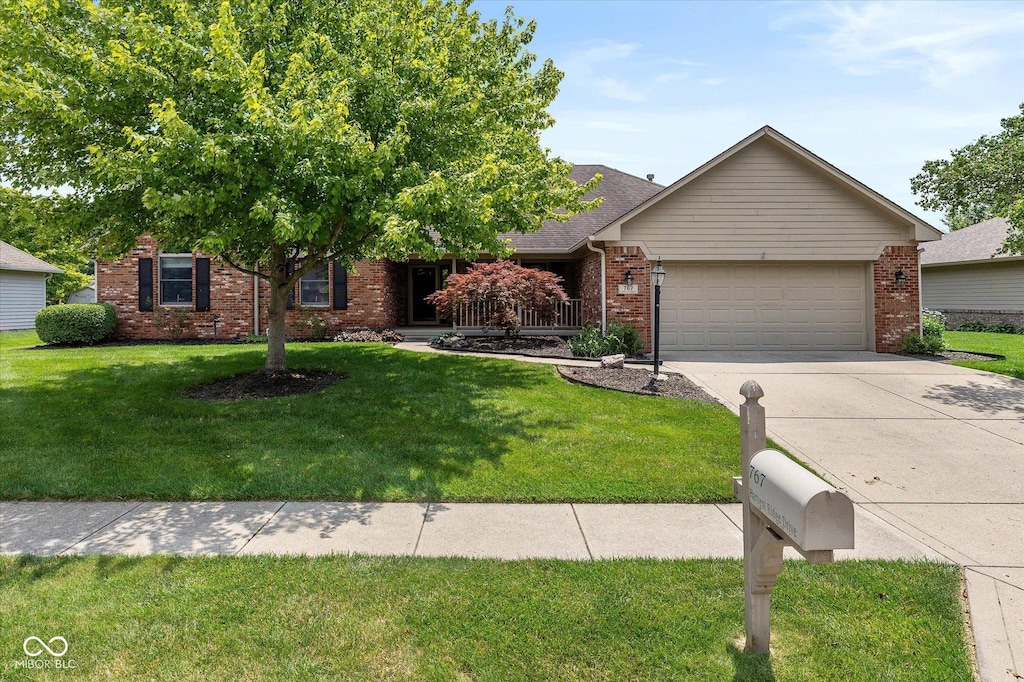 767 Harvest Ridge Dr, Avon, IN 46123 - view of front of home featuring an attached garage, brick siding, driveway, and a front yard