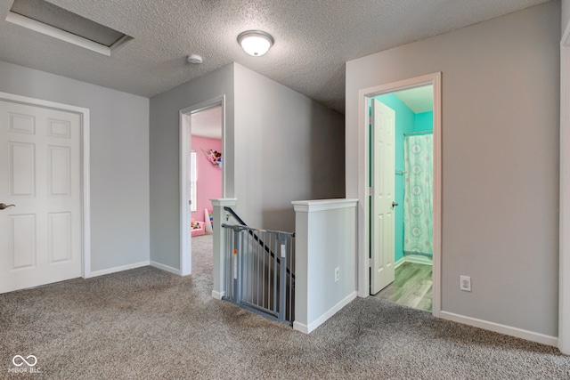 9593 W Constellation Dr, Pendleton, IN 46064 - corridor featuring an upstairs landing, carpet floors, attic access, and a textured ceiling