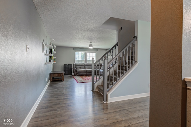 9593 W Constellation Dr, Pendleton, IN 46064 - staircase with a textured wall, a ceiling fan, a textured ceiling, and wood finished floors