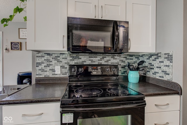 9593 W Constellation Dr, Pendleton, IN 46064 - kitchen featuring black appliances, dark countertops, and white cabinetry