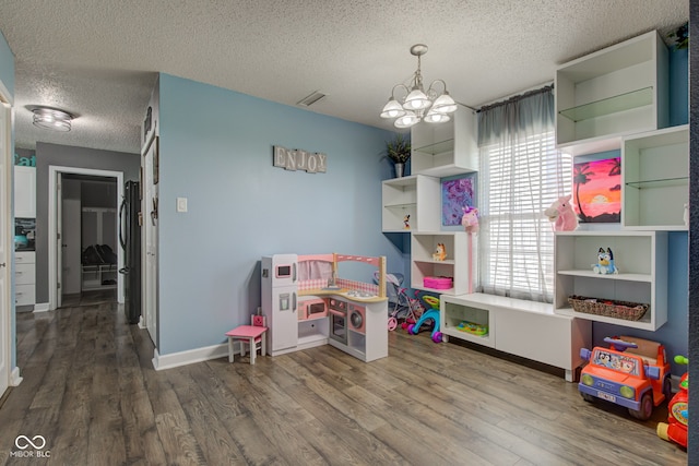 9593 W Constellation Dr, Pendleton, IN 46064 - recreation room featuring a textured ceiling, a chandelier, and wood finished floors