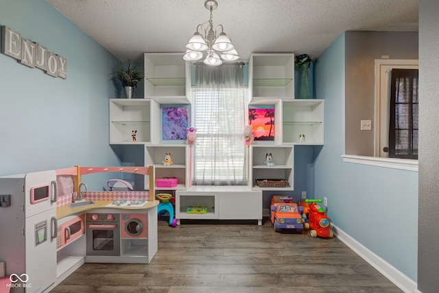 9593 W Constellation Dr, Pendleton, IN 46064 - playroom with a chandelier, a textured ceiling, and wood finished floors