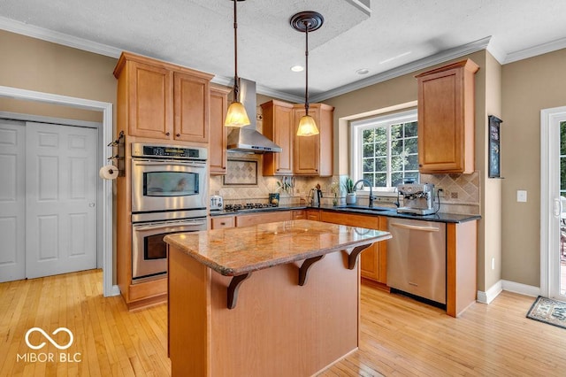 5865 Osage Dr, Carmel, IN 46033 - kitchen with appliances with stainless steel finishes, wall chimney range hood, ornamental molding, light wood finished floors, and dark stone countertops