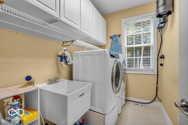 5865 Osage Dr, Carmel, IN 46033 - laundry area with cabinet space, light tile patterned flooring, and washer and dryer