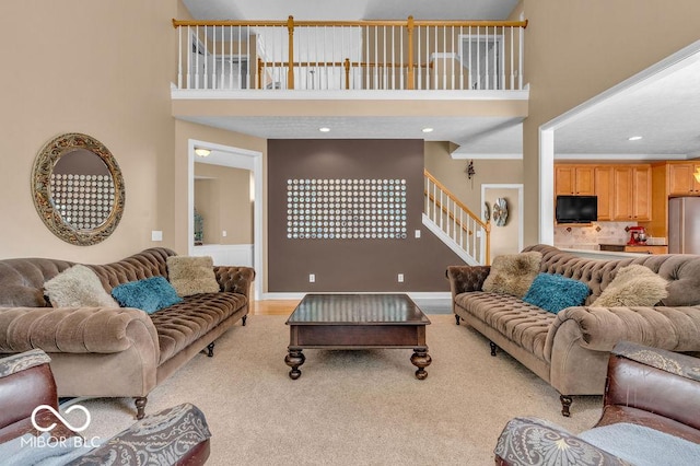 5865 Osage Dr, Carmel, IN 46033 - living room with a high ceiling, stairway, light colored carpet, and recessed lighting