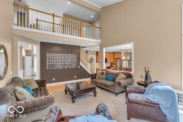 5865 Osage Dr, Carmel, IN 46033 - living area with a high ceiling, stairs, a chandelier, and recessed lighting