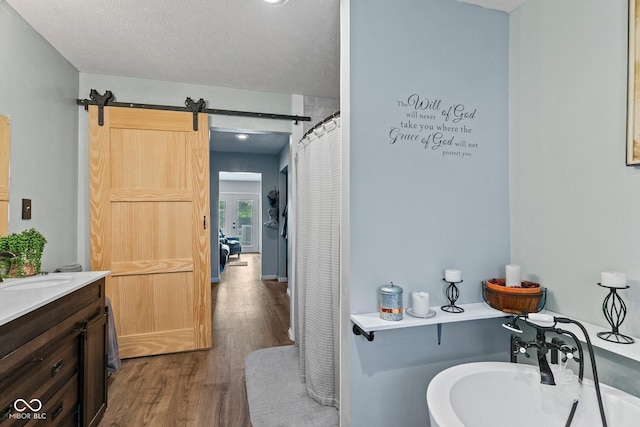 5110 W County Road 400 N, Scipio, IN 47273 - bathroom with wood finished floors, vanity, and a textured ceiling
