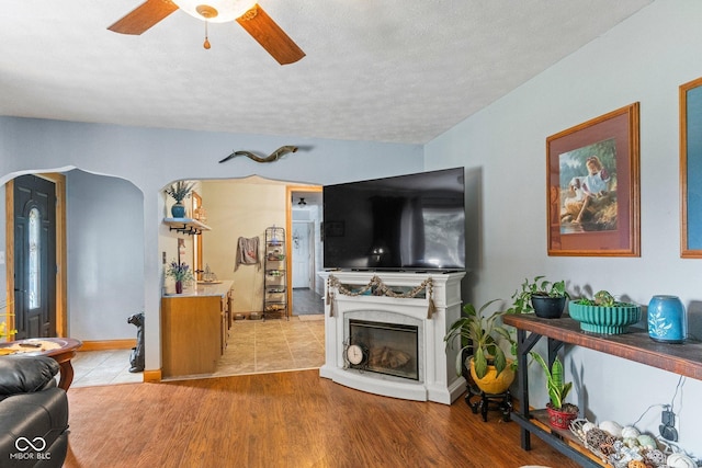 5110 W County Road 400 N, Scipio, IN 47273 - living area featuring ceiling fan, a textured ceiling, a high end fireplace, and light wood-style flooring