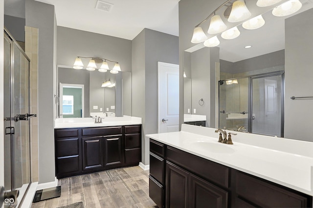 16711 Meadow Wood Dr, Noblesville, IN 46062 - full bath featuring a shower stall, two vanities, and wood finished floors