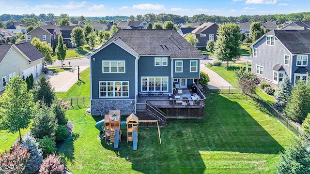 16711 Meadow Wood Dr, Noblesville, IN 46062 - rear view of house with a residential view, a playground, a fenced backyard, and stone siding