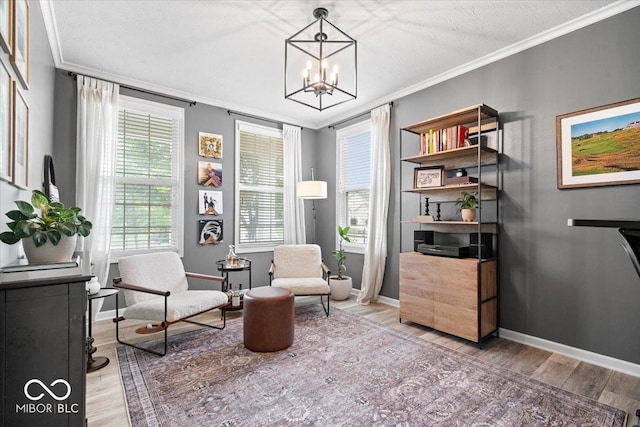 5542 Pennycress Dr, Noblesville, IN 46062 - sitting room with wood finished floors, ornamental molding, and a chandelier