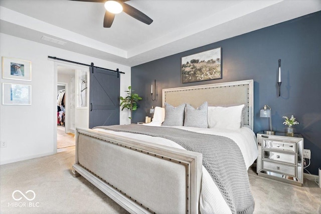 5542 Pennycress Dr, Noblesville, IN 46062 - carpeted bedroom featuring a barn door, a spacious closet, and ceiling fan