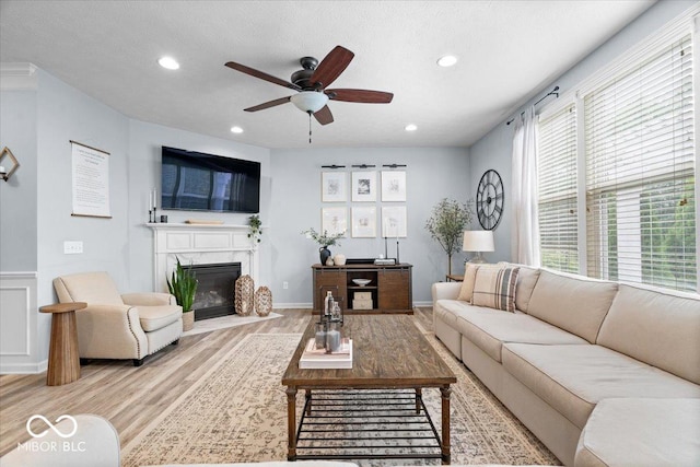 5542 Pennycress Dr, Noblesville, IN 46062 - living room featuring ceiling fan, wood finished floors, healthy amount of natural light, recessed lighting, and a high end fireplace