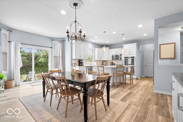 5542 Pennycress Dr, Noblesville, IN 46062 - dining area featuring recessed lighting, a textured ceiling, light wood-style floors, and a chandelier