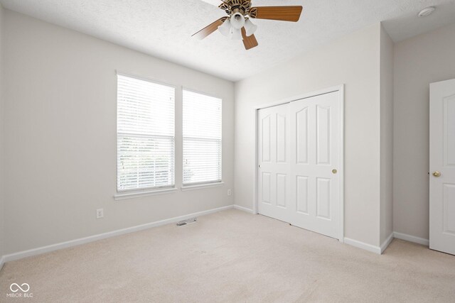 13019 Pinner Ave, Fishers, IN 46037 - unfurnished bedroom with light carpet, a closet, and a ceiling fan