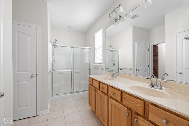13019 Pinner Ave, Fishers, IN 46037 - full bath with double vanity, a shower stall, and tile patterned floors